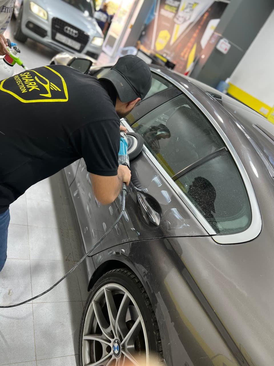 Technician polishing a BMW at the studio
